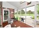 Enclosed back porch with brick accent wall and wicker furniture overlooking the lush lawn at 4670 N 600 E, Franklin, IN 46131