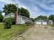 The property showcases a detached two-car garage and a quaint shed next to the main house at 4673 S 400 W, New Palestine, IN 46163