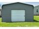 The home's detached garage with roll-up door is shown at 4673 S 400 W, New Palestine, IN 46163
