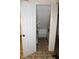 Small, unfinished hallway showcasing shelving and damage to the walls at 515 Hawthorne Ave, Anderson, IN 46011