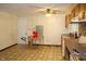 Outdated kitchen featuring wood cabinets, a laminate countertop, and patterned linoleum flooring at 515 Hawthorne Ave, Anderson, IN 46011