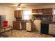 Outdated kitchen featuring wood cabinets, a laminate countertop, and patterned linoleum flooring at 515 Hawthorne Ave, Anderson, IN 46011
