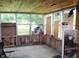 Enclosed sunroom with wood paneling and multiple windows for natural light at 515 Hawthorne Ave, Anderson, IN 46011