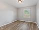Bright bedroom featuring hardwood floors and a window with natural light at 5367 Penway St, Indianapolis, IN 46224