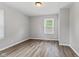 Neutral bedroom features hardwood floors, natural light, and a window at 5367 Penway St, Indianapolis, IN 46224