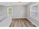 Bright dining area featuring light gray walls, new flooring and windows with blinds at 5367 Penway St, Indianapolis, IN 46224