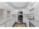 Modern kitchen featuring white cabinets, granite countertops, and stainless steel appliances at 5367 Penway St, Indianapolis, IN 46224