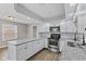 Open kitchen featuring white cabinets, granite countertops, stainless steel appliances, and wood-look flooring at 5367 Penway St, Indianapolis, IN 46224