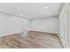 Bright living room with light gray walls, new flooring and recessed lighting at 5367 Penway St, Indianapolis, IN 46224