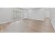 Spacious living room featuring light gray walls, new flooring and a window with blinds at 5367 Penway St, Indianapolis, IN 46224