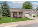Charming brick home featuring a manicured lawn and inviting front porch with rocking chairs at 5515 Gateridge Ln, Indianapolis, IN 46237