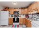 Efficient kitchen layout featuring wood cabinets, bright countertops, and modern appliances perfect for everyday meals at 5515 Gateridge Ln, Indianapolis, IN 46237