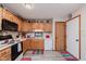 Functional kitchen with white countertops, wood cabinets and modern appliances, offering a practical cooking space at 5515 Gateridge Ln, Indianapolis, IN 46237