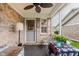 Relaxing sunroom boasts a brick accent wall, ceiling fan, and garden view at 5515 Gateridge Ln, Indianapolis, IN 46237