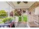 Charming sunroom with a table and chairs overlooking a lush backyard at 5515 Gateridge Ln, Indianapolis, IN 46237