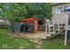 Backyard of house with BBQ grill, shed, trashcans, and brick patio at 5614 Regency Dr, Indianapolis, IN 46224