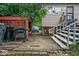 Backyard of house with BBQ grill, trashcans, shed, and brick patio at 5614 Regency Dr, Indianapolis, IN 46224