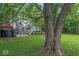 Spacious backyard with deck, trees, and a storage shed at 5614 Regency Dr, Indianapolis, IN 46224