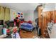 Bedroom features a laminate floor, ceiling fan, and a gaming chair at 5614 Regency Dr, Indianapolis, IN 46224