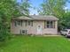 Charming two-story home featuring a well-manicured lawn and beautiful surrounding trees at 5614 Regency Dr, Indianapolis, IN 46224