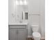 Well-lit bathroom featuring a gray vanity with a white countertop, a large mirror, and a white toilet at 5673 Stetson Dr, Whitestown, IN 46052