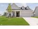 Charming new construction home with a manicured lawn and a two-car attached garage at 5673 Stetson Dr, Whitestown, IN 46052