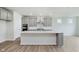 Beautiful kitchen with gray cabinets, stainless steel appliances, a center island, and hardwood floors at 5673 Stetson Dr, Whitestown, IN 46052