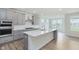 Open kitchen featuring gray cabinets, a large island, stainless steel appliances, and hardwood floors at 5673 Stetson Dr, Whitestown, IN 46052