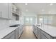 Bright kitchen with stainless steel appliances, a large island, subway tile backsplash, and hardwood floors at 5673 Stetson Dr, Whitestown, IN 46052