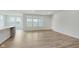 Open living space with beautiful wood floors and large windows for ample natural light at 5673 Stetson Dr, Whitestown, IN 46052