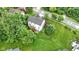 Aerial view showcasing a well-manicured lawn, a wooden deck, and mature trees surrounding a charming two-story home at 5857 Stone Pine Trl, Carmel, IN 46033