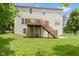 Backyard featuring a wooden deck with stairs leading to a spacious, well-maintained lawn, perfect for outdoor activities at 5857 Stone Pine Trl, Carmel, IN 46033
