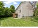 Spacious backyard featuring a wooden deck, lush lawn, and a black metal fence, providing a private and inviting outdoor space at 5857 Stone Pine Trl, Carmel, IN 46033