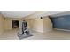 Finished basement with tile flooring and exercise equipment near stairs at 5857 Stone Pine Trl, Carmel, IN 46033