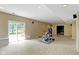 Bright basement with tile flooring, exercise equipment, and sliding glass door at 5857 Stone Pine Trl, Carmel, IN 46033