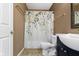 Neutral bathroom featuring a floral shower curtain, toilet, and vanity at 5857 Stone Pine Trl, Carmel, IN 46033