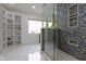 Contemporary bathroom featuring walk-in glass shower, shelving and double sink at 5857 Stone Pine Trl, Carmel, IN 46033
