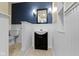 Charming powder room featuring decorative wainscotting, a modern vanity, and a framed mirror, offering a stylish space at 5857 Stone Pine Trl, Carmel, IN 46033