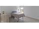 A simple bedroom is furnished with a wooden dresser and a twin bed at 5857 Stone Pine Trl, Carmel, IN 46033