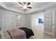 Comfortable bedroom featuring ample closet space, stylish french doors, and neutral walls, creating a relaxing environment at 5857 Stone Pine Trl, Carmel, IN 46033
