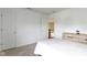 A spacious bedroom featuring a white bed, dresser, and neutral carpet at 5857 Stone Pine Trl, Carmel, IN 46033