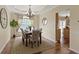 Elegant dining room with chandelier, hardwood floors and natural light at 5857 Stone Pine Trl, Carmel, IN 46033