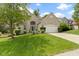 Charming brick home with an attached two-car garage and a well-maintained green lawn at 5857 Stone Pine Trl, Carmel, IN 46033