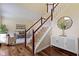 Elegant foyer featuring hardwood floors, a staircase, and access to the living room at 5857 Stone Pine Trl, Carmel, IN 46033