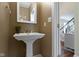 Charming half bathroom featuring a pedestal sink and neutral decor at 5857 Stone Pine Trl, Carmel, IN 46033