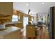 View of a kitchen with wood floors that flows into a dining area and a living room with a fireplace at 5857 Stone Pine Trl, Carmel, IN 46033