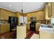 Spacious kitchen featuring wooden cabinets, a black refrigerator, and a central island with pendant lighting at 5857 Stone Pine Trl, Carmel, IN 46033
