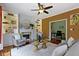 Living room with built-in shelves flanking a fireplace, connected to an adjacent office space at 5857 Stone Pine Trl, Carmel, IN 46033