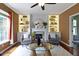 Cozy living room featuring a fireplace, built-in shelves, and a round glass coffee table at 5857 Stone Pine Trl, Carmel, IN 46033