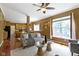 Open-concept living room boasts hardwood floors, gray sofa, and seamless flow to the kitchen at 5857 Stone Pine Trl, Carmel, IN 46033